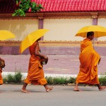 Modern day Buddhism evolution-monks-with-umbrella-w-53276842